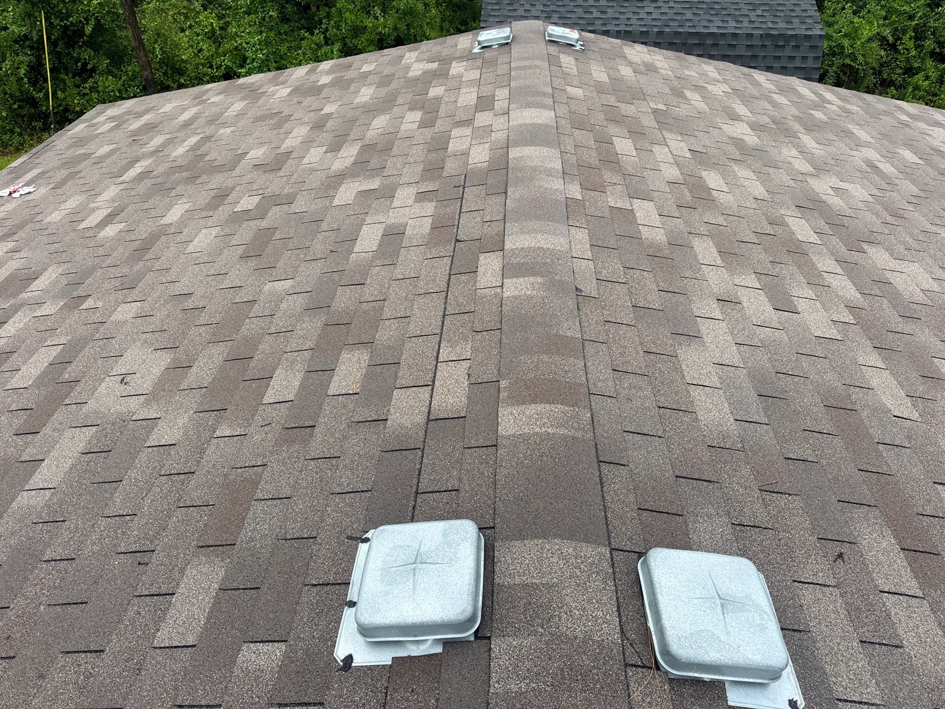 Completed architectural shingle roof with ridge and box vents