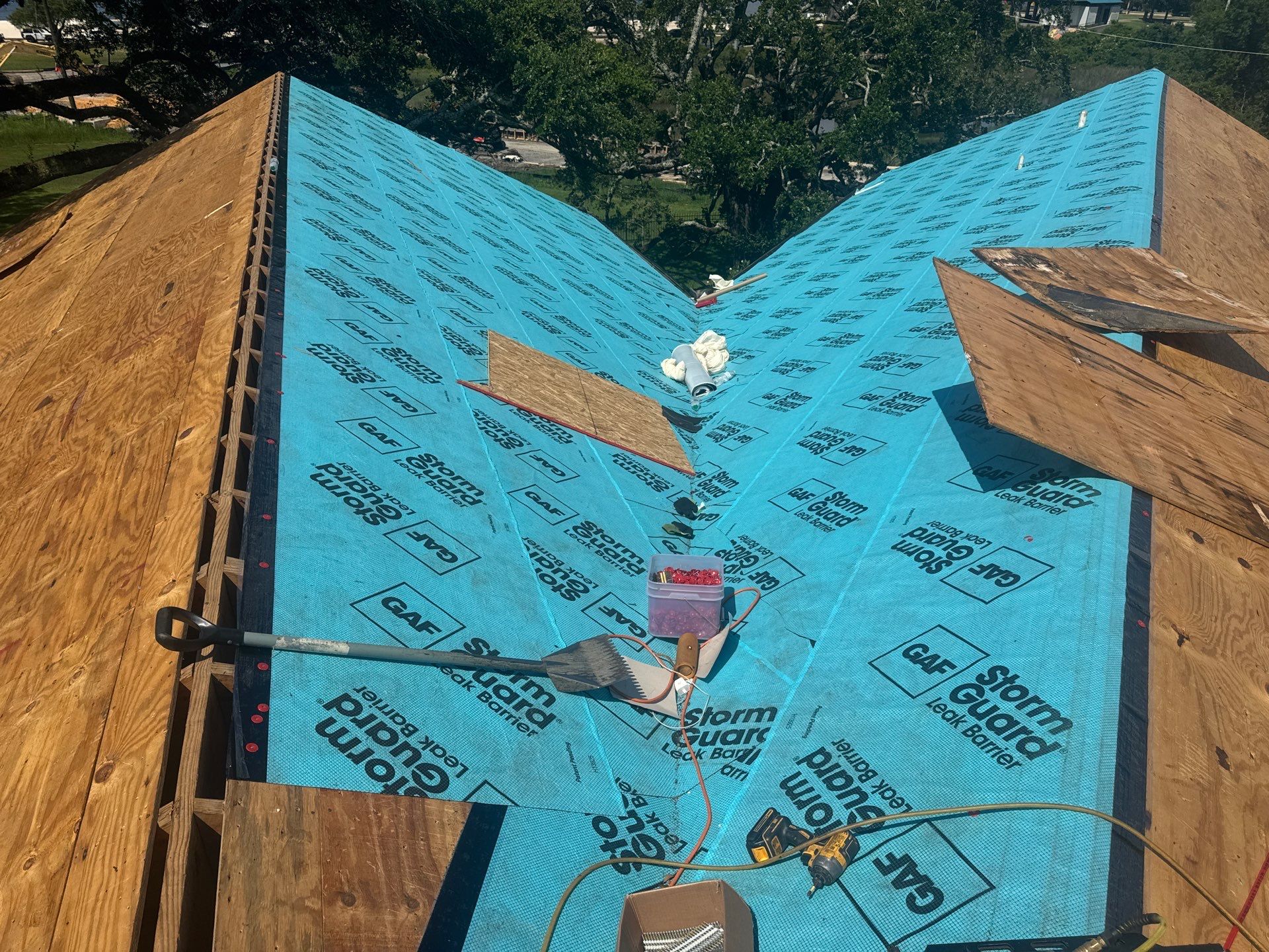 Fresh plywood decking with GAF StormGuard leak barrier installed in the roof valley