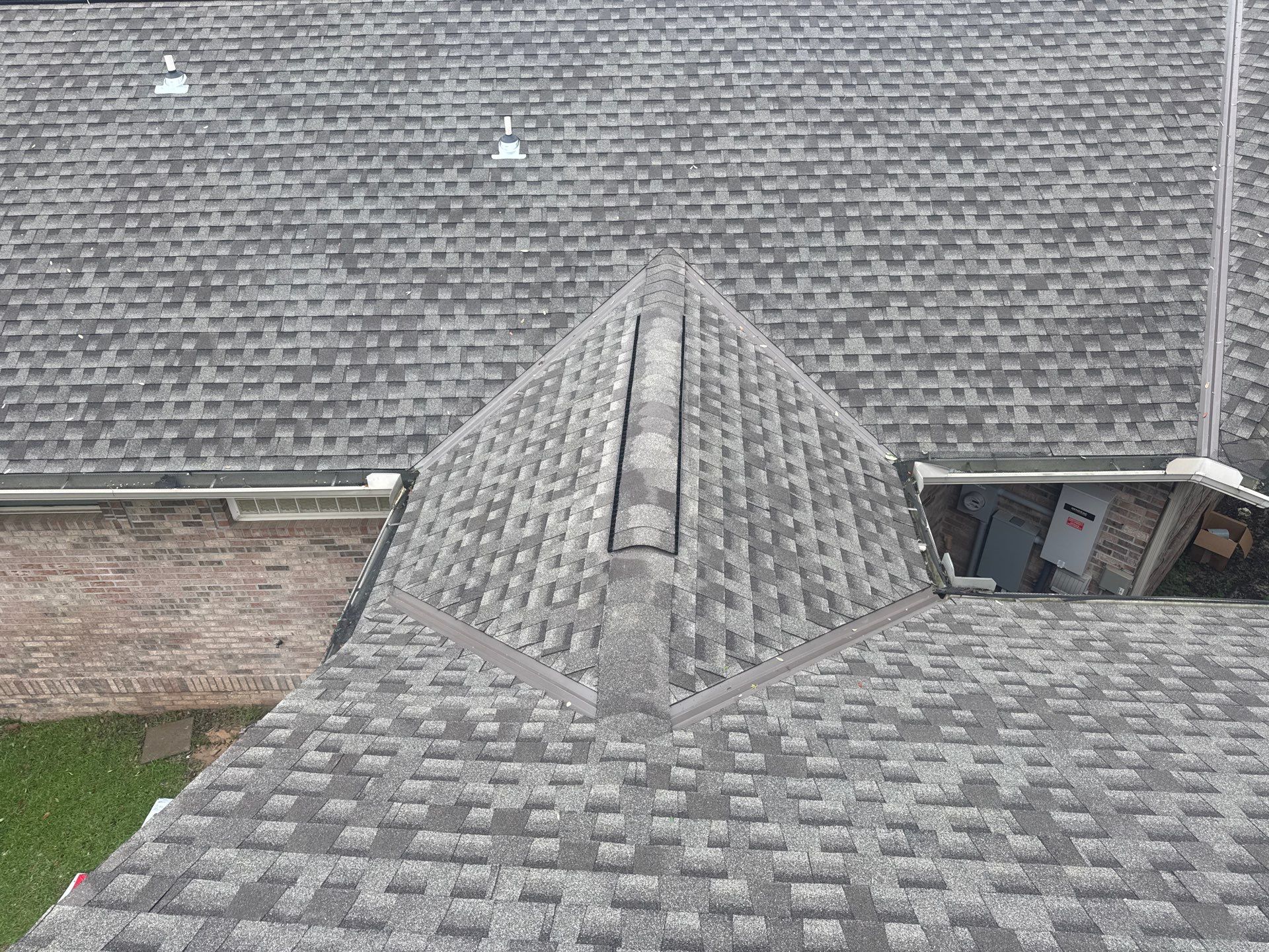 Aerial view of architectural shingle roof with clean hip and ridge detail